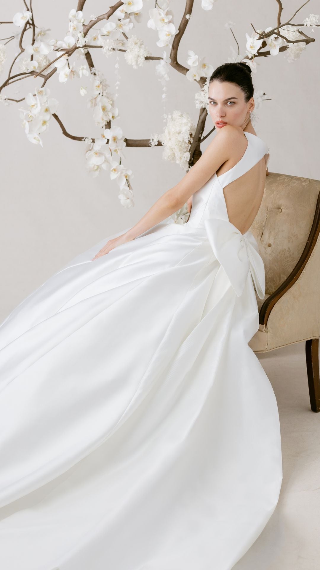 Elegantes Brautkleid von Morilee, präsentiert mit zarten Blumen im Hintergrund, perfekte Wahl für den großen Tag.