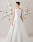 Elegantes Brautkleid von Morilee, präsentiert mit zarten Blumen im Hintergrund, perfekte Wahl für den großen Tag.